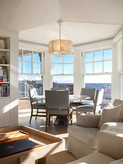 a living room with furniture a window and a table