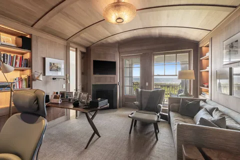 a living room with furniture window and a fireplace
