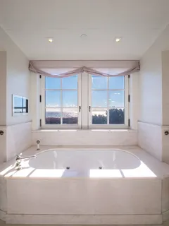 a bathroom with a bathtub and window