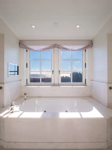 a bathroom with a bathtub and window