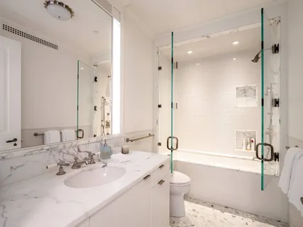 a bathroom with a tub sink and mirror