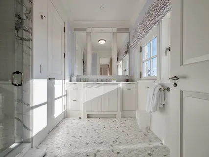 a bathroom with a double vanity sink mirror and shower