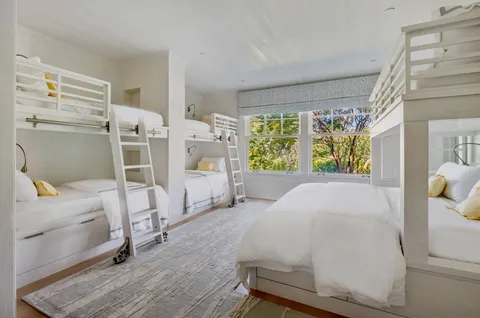 a bed room with a bed and a chair