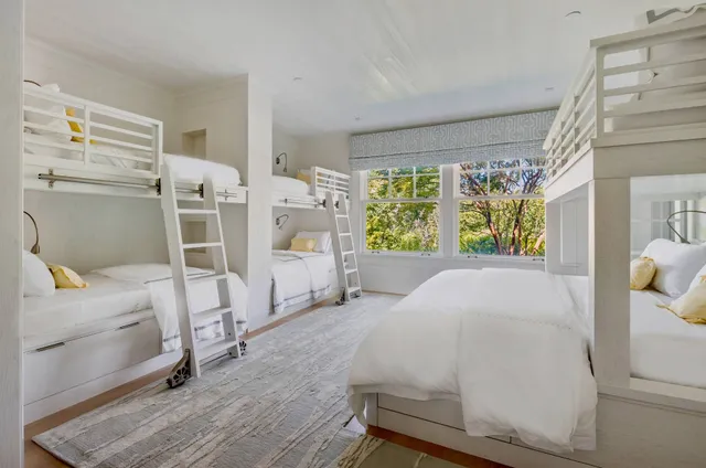 a bed room with a bed and a chair