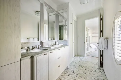 a bathroom with a sink a toilet a shower and a mirror