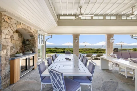 a living room with furniture a chandelier and a floor to ceiling window