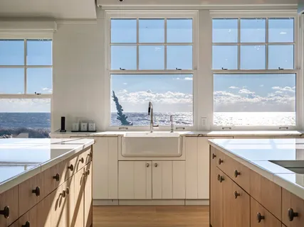 a kitchen with a sink stove and cabinets