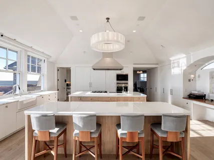a kitchen with a dining table and chairs