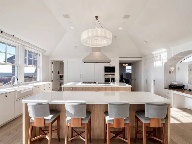 a kitchen with a dining table and chairs