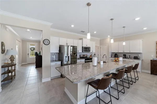 a large kitchen with a table and chairs