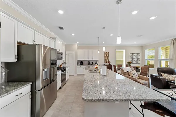a large kitchen with stainless steel appliances kitchen island granite countertop a large counter top stainless steel appliances and cabinets