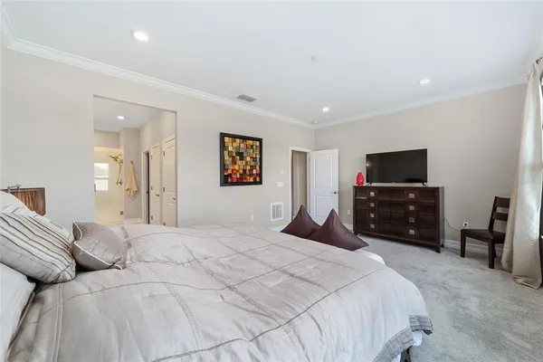 a bedroom with a bed and a television