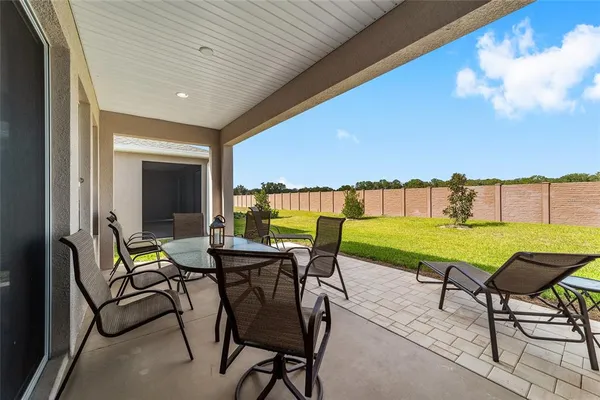 a view of chairs and table in patio