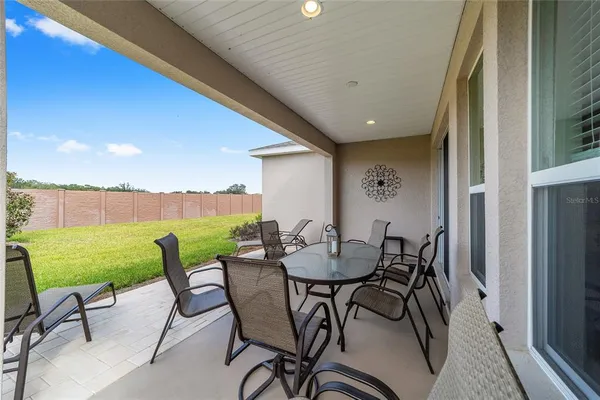 a view of an outdoor dining space with furniture and garden