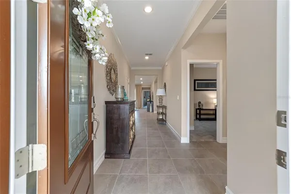 a view of a hallway with dining table and chairs