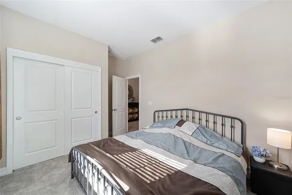 a bedroom with a bed and a lamp