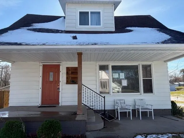 a front view of a house with outdoor seating