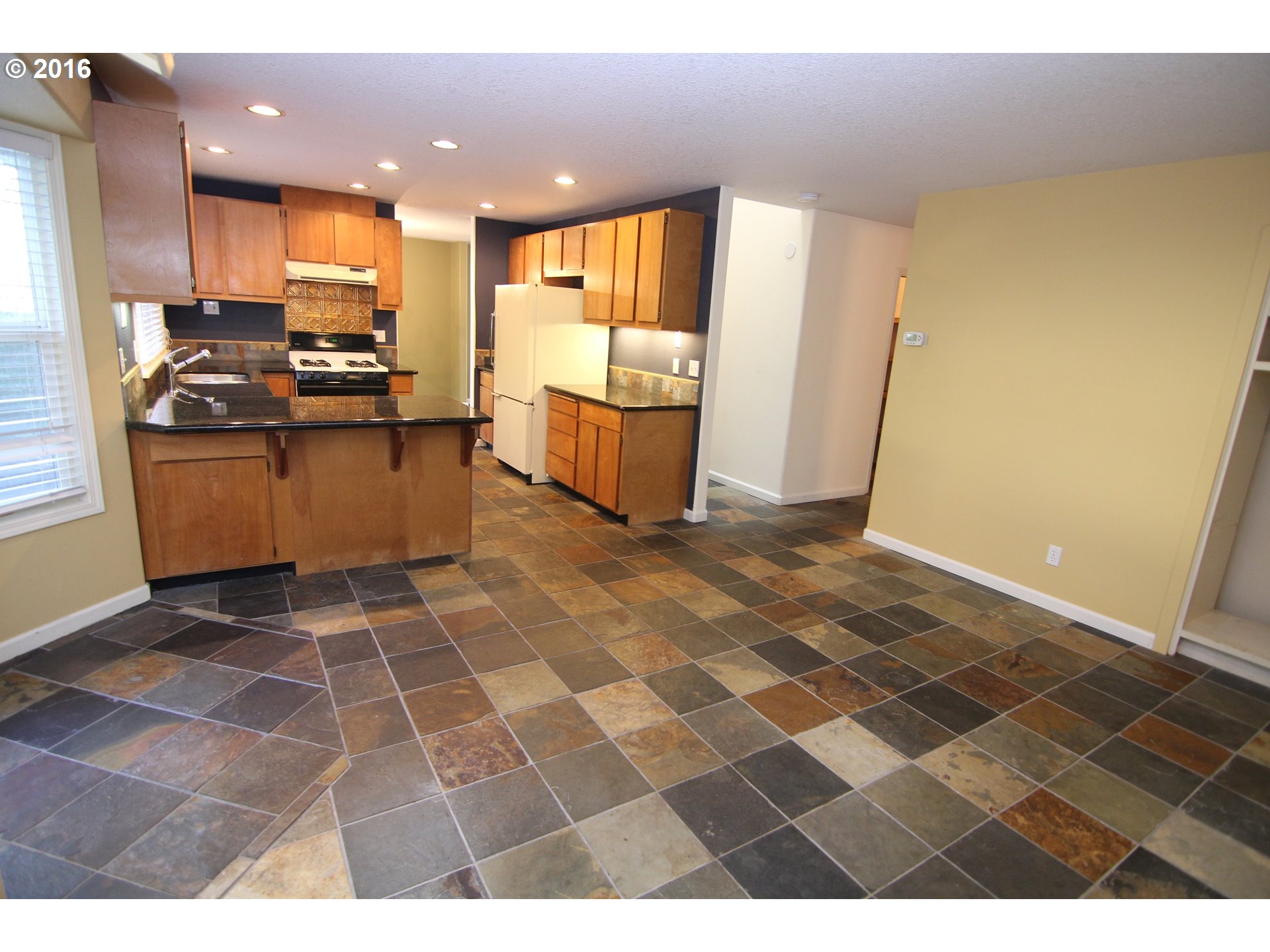 2525 Sunset Avenue West Linn, OR 97068 - Photo 11 of 25 a kitchen with granite countertop a stove a sink and a refrigerator