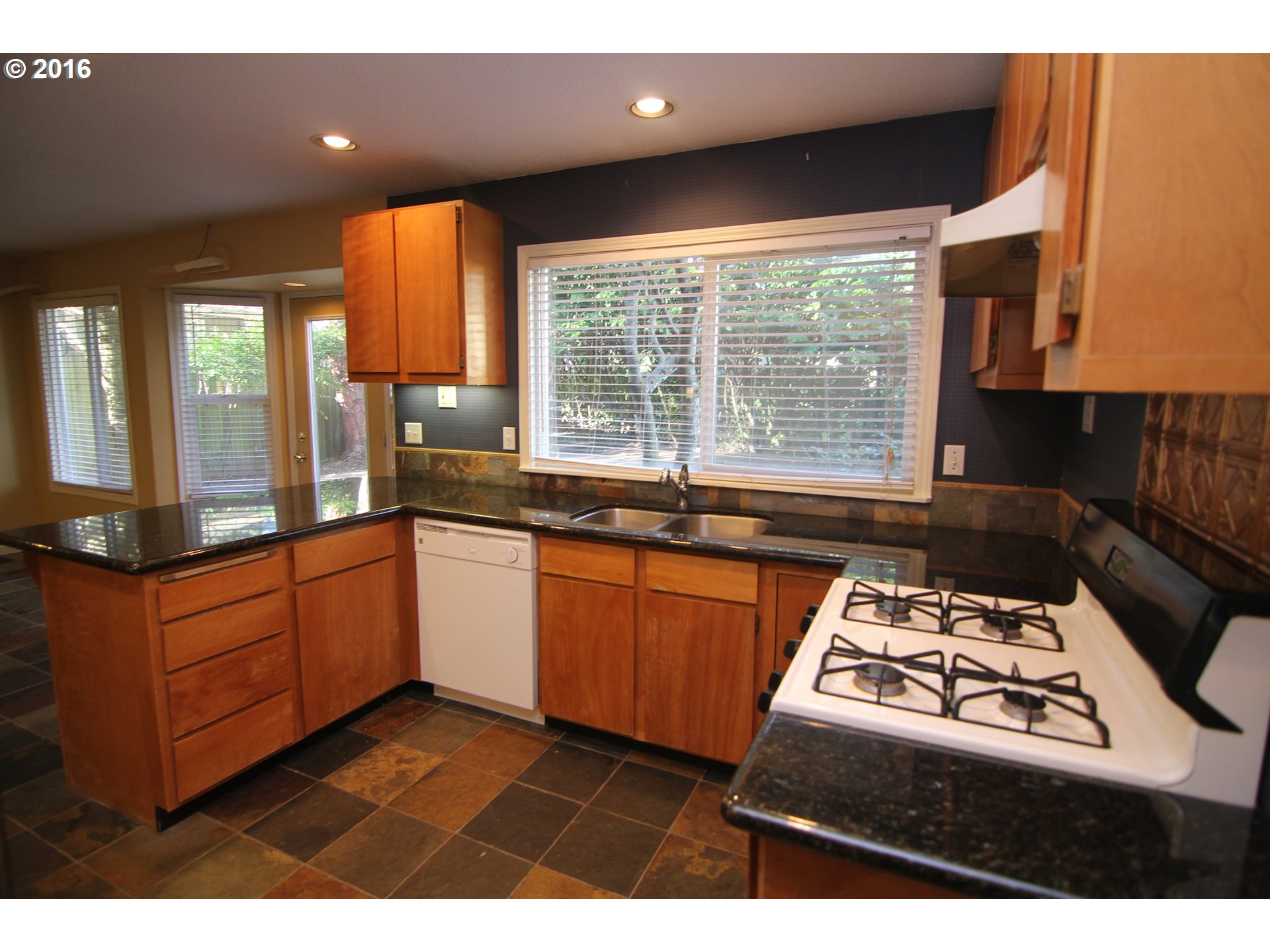 2525 Sunset Avenue West Linn, OR 97068 - Photo 8 of 25 a kitchen with stainless steel appliances granite countertop a stove a sink and a microwave