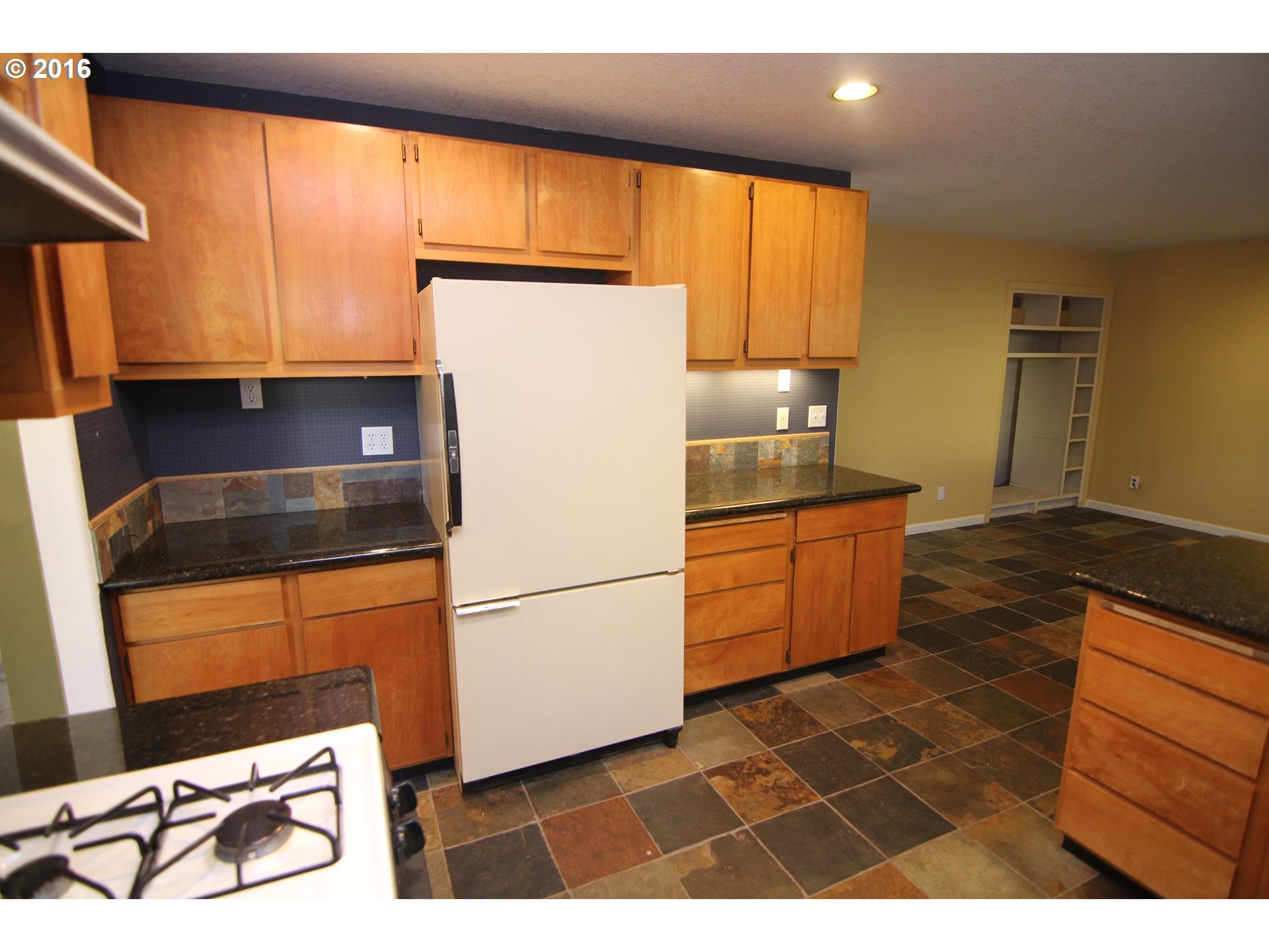 2525 Sunset Avenue West Linn, OR 97068 - Photo 9 of 25 a kitchen with granite countertop a refrigerator a stove a sink and a microwave