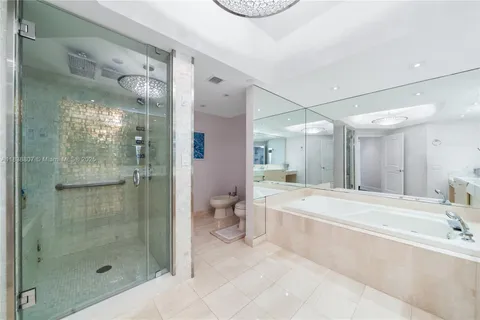 a bathroom with a bathtub shower sink and toilet