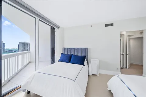 a bedroom with a large bed and a large window