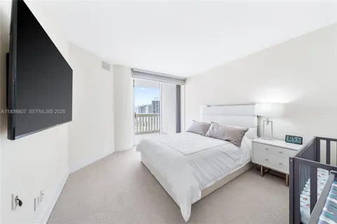 a bedroom with a bed and large window