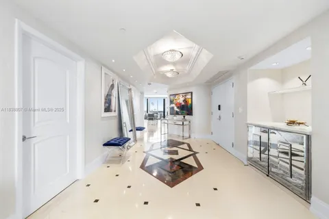 a living room with furniture a large window and white walls