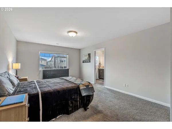 a bedroom with a bed and a lamp