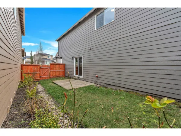a view of a backyard with plants and a patio