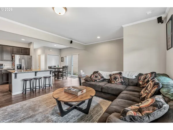 a living room with furniture and a dining table