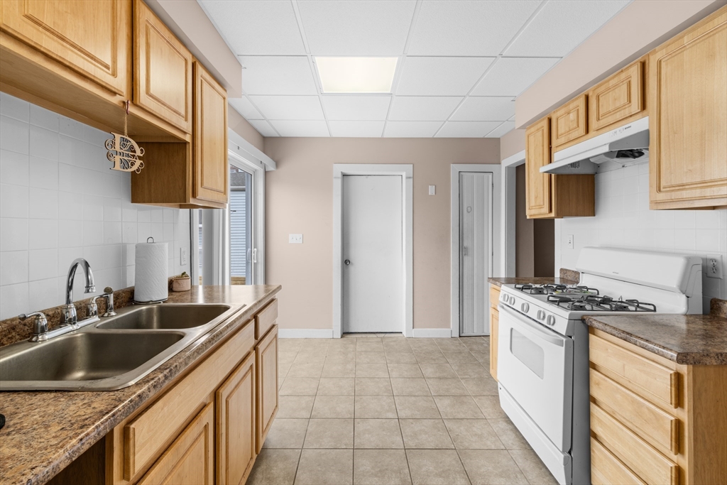 173 Whipple Street Fall River, MA 02721 - Photo 16 of 41 a kitchen that has a sink and a stove
