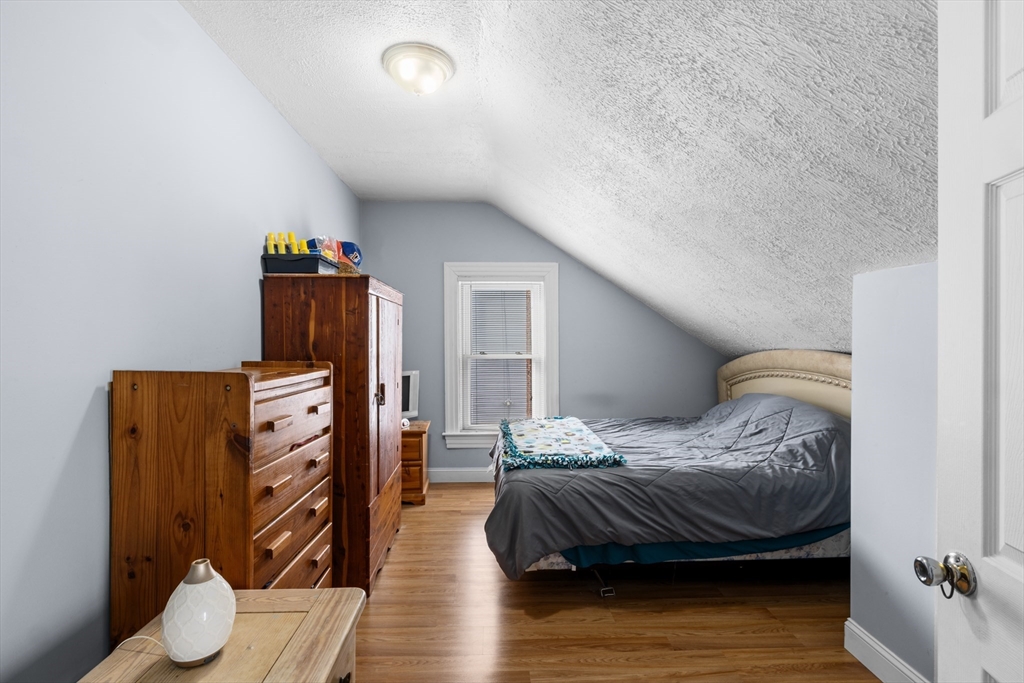 173 Whipple Street Fall River, MA 02721 - Photo 22 of 41 a bedroom with furniture and wooden floor