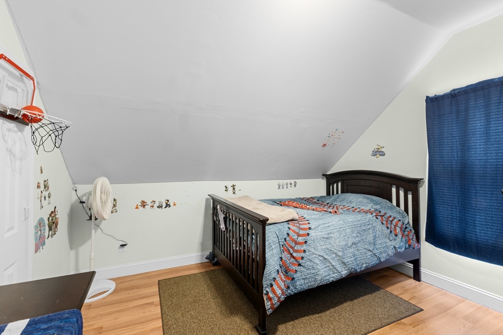 173 Whipple Street Fall River, MA 02721 - Photo 23 of 41 a bedroom with a bed and wooden floor