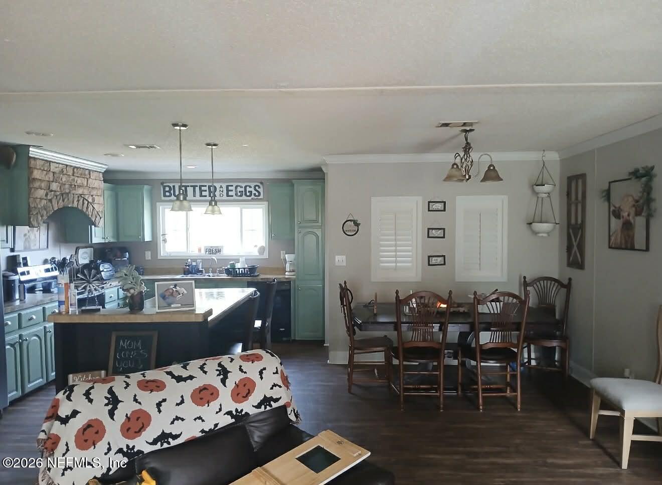 1670 Dennis Howell Road Perry, FL 32348 - Photo 13 of 15 a kitchen with stainless steel appliances a dining table and chairs
