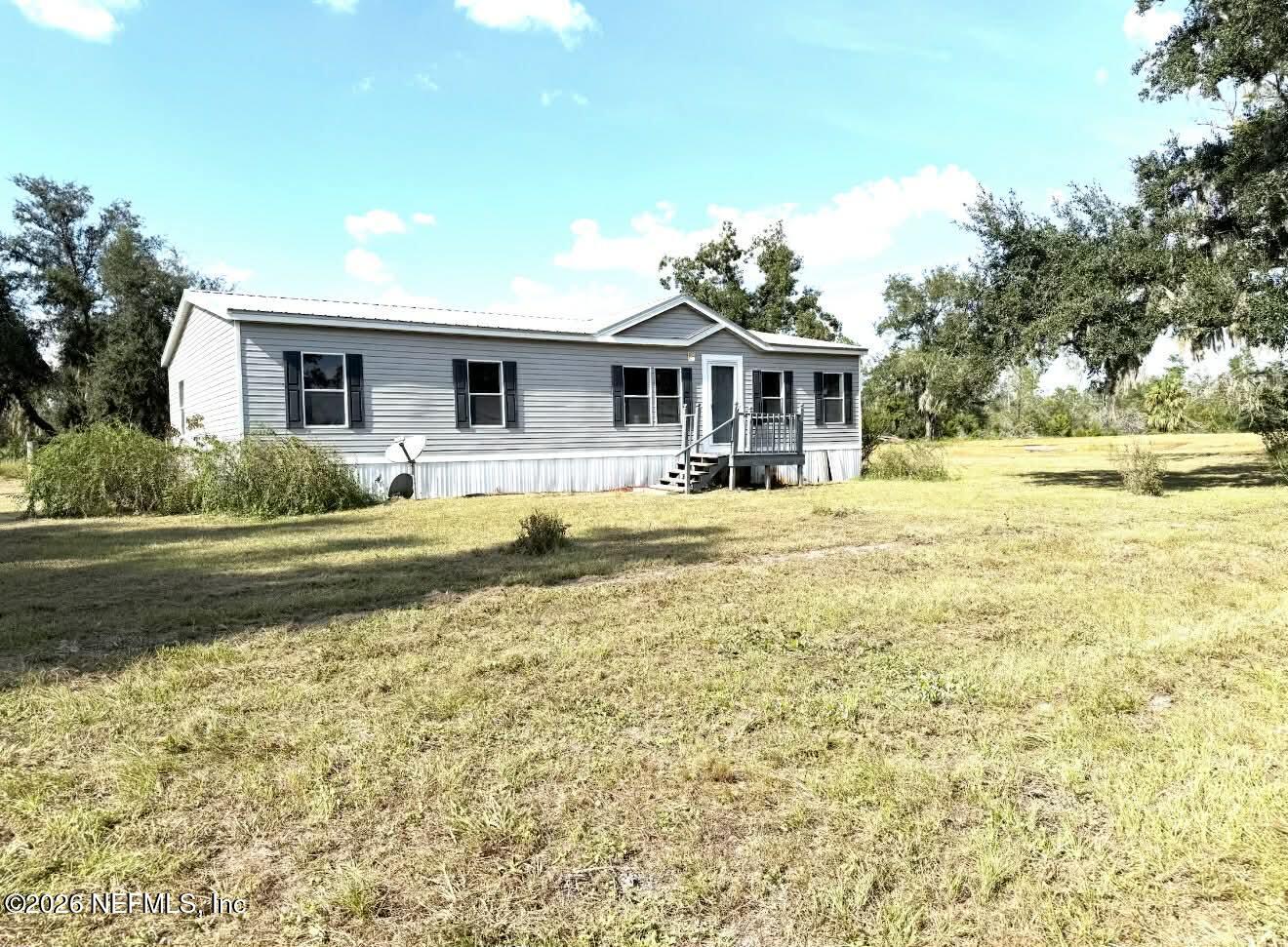 1670 Dennis Howell Road Perry, FL 32348 - Photo 4 of 15 a house with swimming pool in front of it