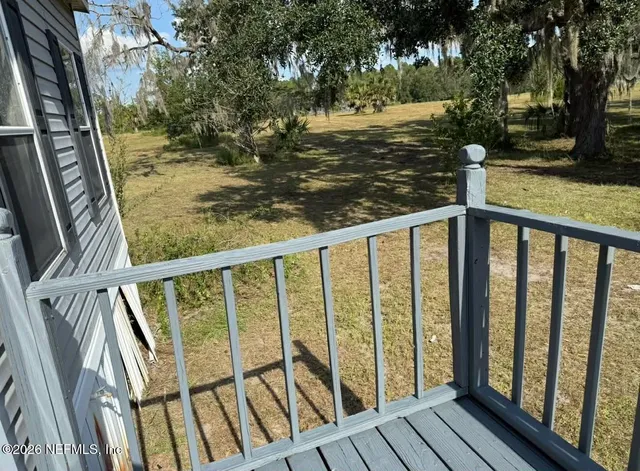 a view of a balcony with wooden floor