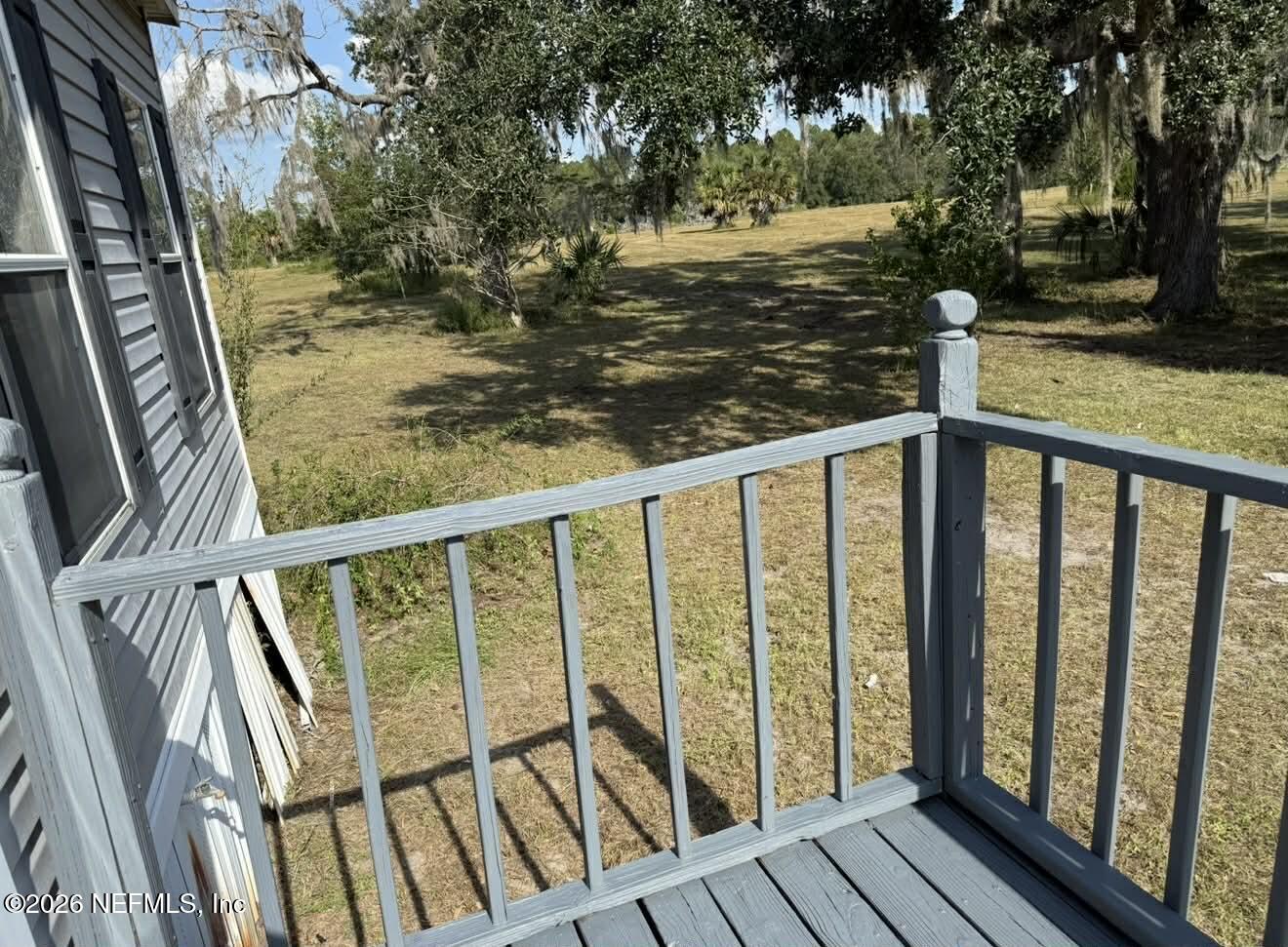 1670 Dennis Howell Road Perry, FL 32348 - Photo 6 of 15 a view of a balcony with wooden floor