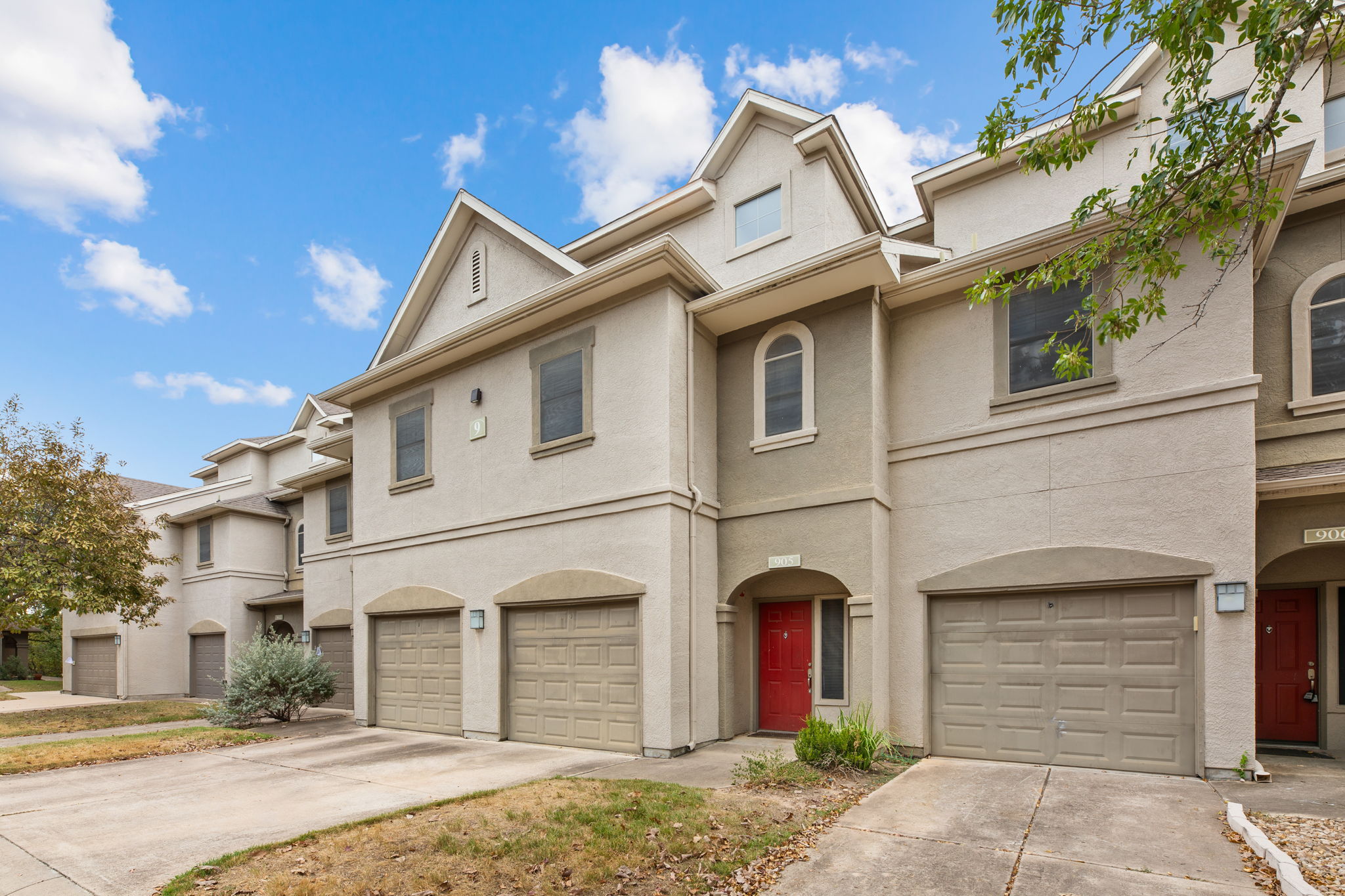 11203 Ranch Road 2222, Unit 905 Austin, TX 78732 - Photo 2 of 27 a view of a white house with a large tree