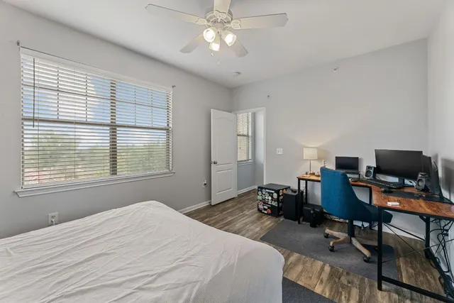 a bedroom with a bed window and a desk