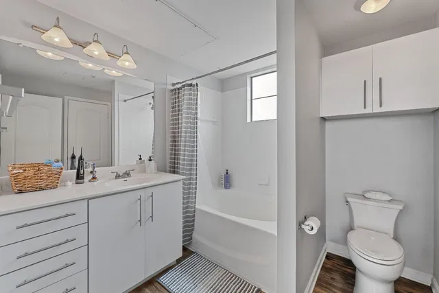 a bathroom with a tub sink toilet and mirror