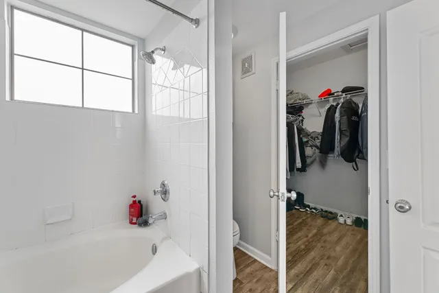 a view of a walk in closet and bathroom