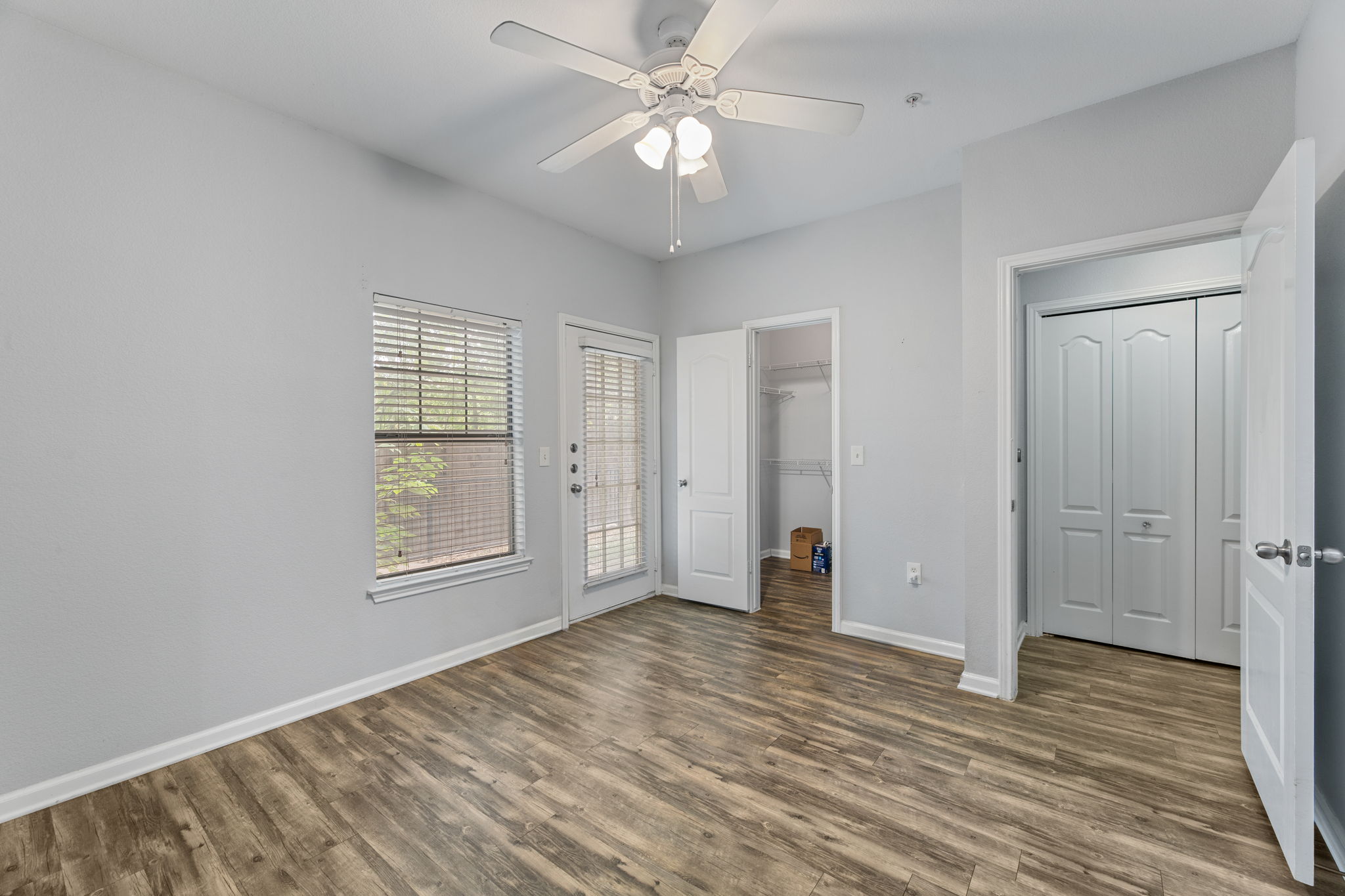 11203 Ranch Road 2222, Unit 905 Austin, TX 78732 - Photo 4 of 27 wooden floor in an empty room with a window