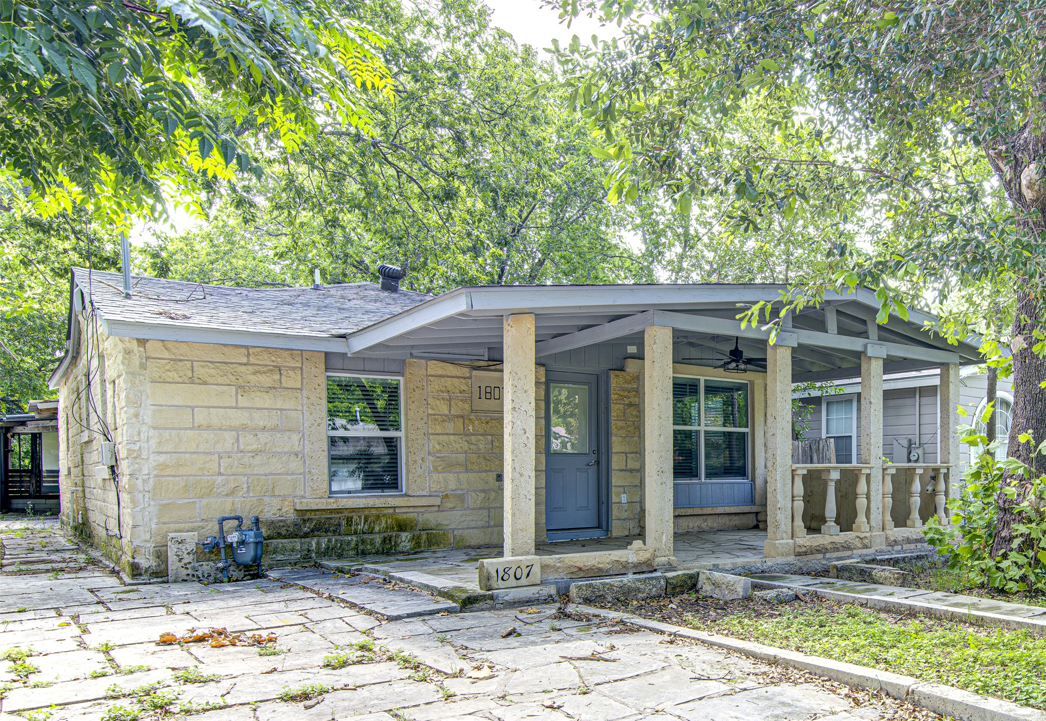 1807 San Jose Street Georgetown, TX 78626 - Photo 2 of 21 Stone block facade welcomes you to a charming, tree-shaded residence with a broad covered front porch.