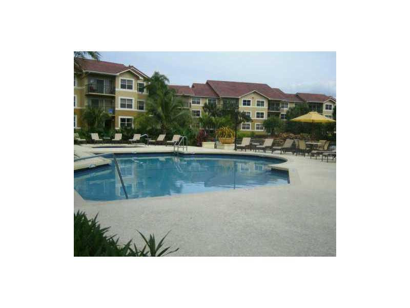 8977 Wiles Road, Unit 1052 Coral Springs, FL 33067 - Photo 4 of 8 a view of swimming pool from a terrace