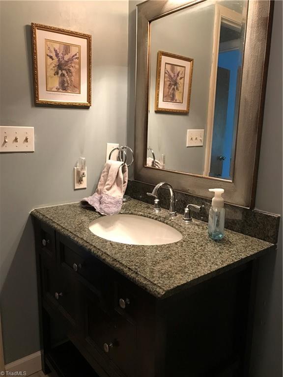 230 Hicks Road Lexington, NC 27295 - Photo 22 of 30 2nd full bath on Main level. This bath also has new vanity with granite counter and backsplash.