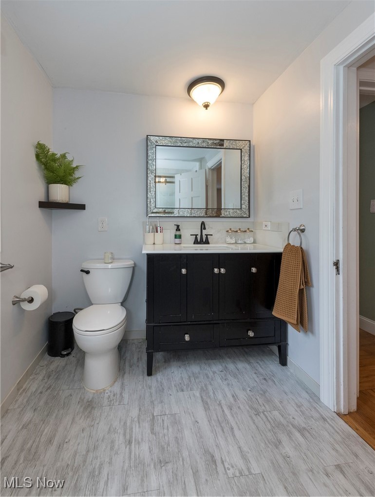 33716 Baldwin Road Solon, OH 44139 - Photo 27 of 40 Bathroom with hardwood / wood-style flooring, vanity, and toilet