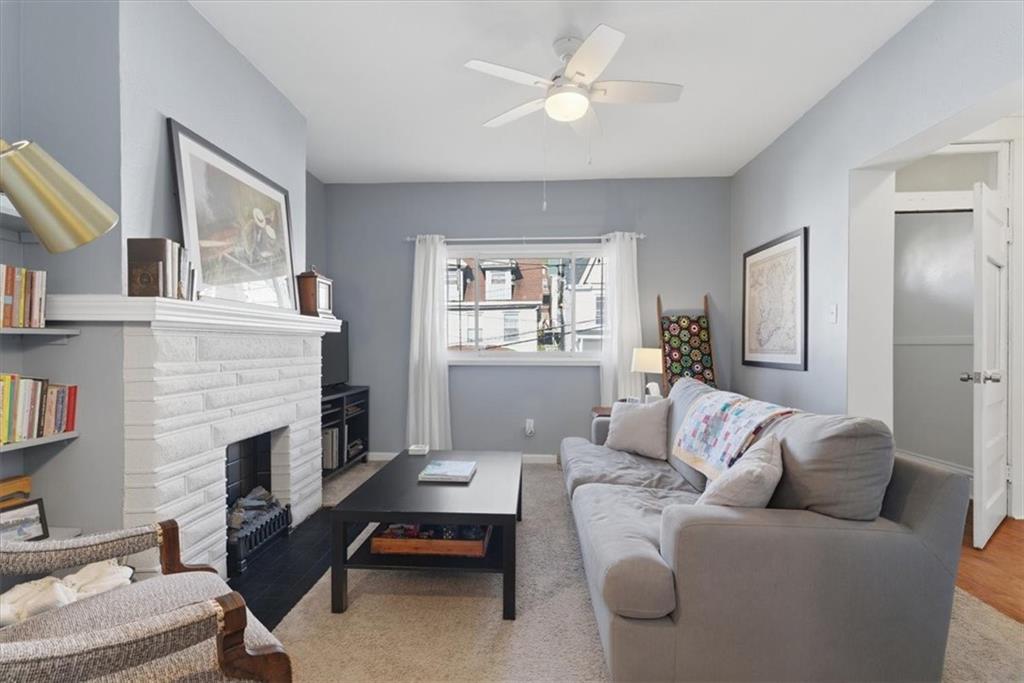 246 Dunseith Street Pittsburgh, PA 15213 - Photo 5 of 36 a living room with furniture a fireplace and a window