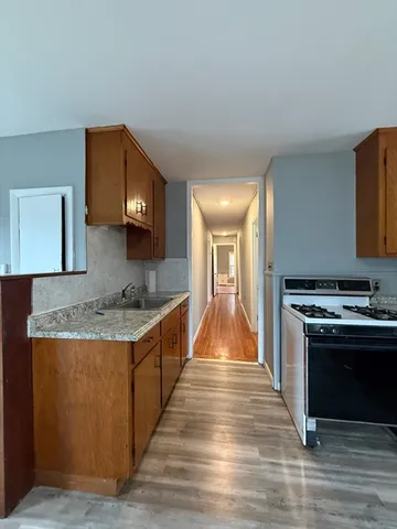 a kitchen with stainless steel appliances granite countertop a stove and a sink