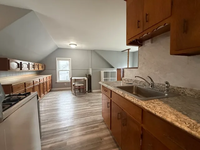 a kitchen with sink stove and cabinets